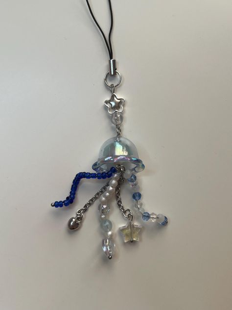 handmade with love! cute blue beaded star jellyfish keychain / phone charm - no returns, all sales final - each item is handcrafted with care but still susceptible to flaws. please be careful!  - keep away from dirt/water to minimize tarnishing. wipe clean with cloth as needed! please message if you have any questions or concerns. thank you for supporting my small business! handmade and owned by one crafty gal <3 Cute Bead Keychain Ideas, How To Make Charms For Phone, Jellyfish Phone Charm, Bead Jellyfish, Jellyfish Beads, Resin Jellyfish, Beaded Keychain Ideas, Star Jellyfish, Chain Jewelry Diy