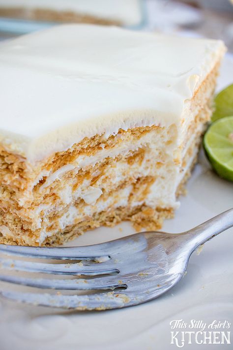 Key Lime Eclair Cake, layers of creamy filling bursting with key lime flavor between graham crackers, topped with vanilla frosting. Tastes just like a key lime pie, but much easier! from ThisSillyGirlsLife.com #keylimepie #eclaircake Key Lime Eclair Cake, Key Lime Recipes, Eclair Cake Recipes, Icebox Cakes, Lime Desserts, Ganache Frosting, Eclair Cake, Lime Recipes, Layered Desserts