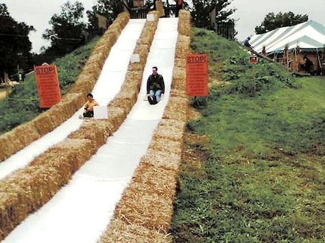 Richard Graves and son Evan slide down one of the carpet slides at the Burke Nursery Pumpkin Playground last year. Slide On A Hill, Playground On Hill, Hay Bale Slide, Slide In Ground, Playground Road Track, Modern Playground, Backyard Fort, Playground Slide, Pumpkin Festival