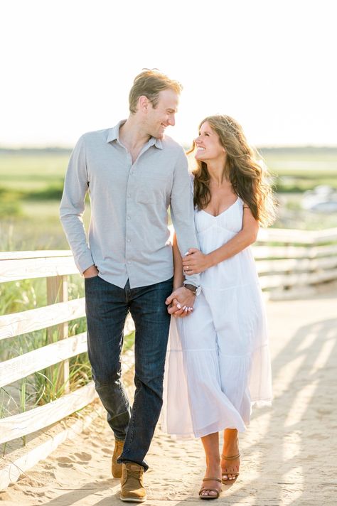 Couple walking hand in hand along the path to Plum Island beach. Dressy outfit idea for engagement photos. Photography by Sarah Surette, a Boston and New England Photographer. Nantucket Engagement Photos, Engagement Photography Outfits, Walking Hand In Hand, Plum Island, Couple Outfit Ideas, Couple Walking, Newport Wedding, Dressy Outfit, Engagement Session Outfits