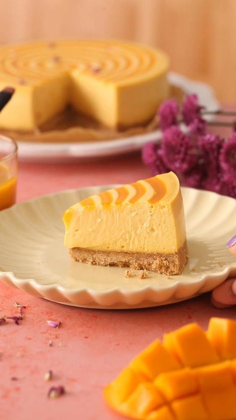 This tasty baked mango cheesecake combines the decadent creaminess of a classic cheesecake with the tropical flavor of mango. It is basically summer in a cake slice form! The velvety smooth cheesecake recipe is made with mango puree (mango pulp), eggs, cream cheese and a touch of sour cream (we need that tang!). Make it for summer bbqs, birthdays, baby showers or just about any occasion! Baked Mango, Eggs Cream Cheese, Slice Form, Fun Cheesecake Recipes, Mango Dessert Recipes, Mango Pulp, Cheesecake Toppings, Mango Dessert, Cream Cheese Desserts