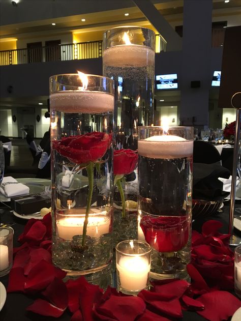 Roses In Water Centerpiece Floating Candles, February Sweet 16 Ideas, Red Rose Reception Decoration, Red And White Centerpieces Quinceanera, Small Red Centerpieces, Red Black And Gold Centerpieces Birthday, Red Black Centerpieces, Quinceñera Centerpiece Ideas Red, Red Sweet 16 Centerpieces