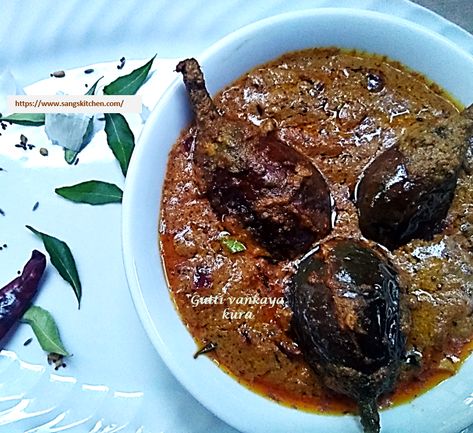 Gutti vankaya Kura is a delicious, lip-smacking, spicy and tangy, Andhra style stuffed brinjal gravy prepared with small brinjals and special Andhra kura masala. Gutti Vankaya Andhra, Baigan Recipes, Gutti Vankaya, Hebbars Kitchen, Hebbar's Kitchen, Fenugreek Seeds, Coriander Seeds, Cinnamon Sticks, Gravy