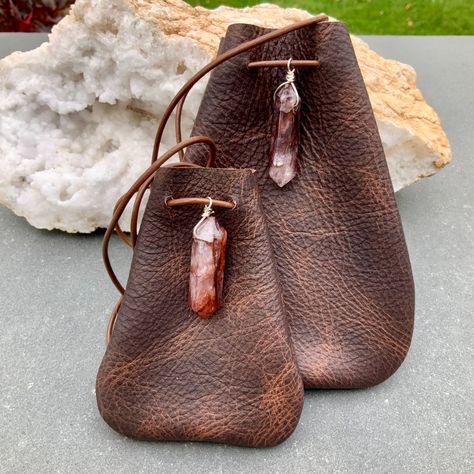 "Red Quartz (Lepidocrocite)Double point Crystal on an Autumn Brown Distressed Leather Medicine Leather Pouch.  Red Quartz is a beautiful Stone-it has a deep inner sparkle that makes it glow. It does not seem to like to be photographed-I could not capture the inner glow.It is much more beautiful than my pictures! Mojo Bag, Shaman Bag or Amulet Pouch to wear around your neck-or hang in your Car! Perfect for Ceremony or as a special Keepsake. Beautiful on your Altar and an excellent Gift got Him! A place for things that have Spiritual Meaning for you-like that pretty rock your 3 year old gave  you! Two sizes: Small 3 3/4\"deep 2 3/4\"wide Large 5 1/4\"deep 4\"wide Please note all Gemstones vary slightly." Diy Leather Medicine Pouch, Medicine Bag Diy, Leather Pouch Necklace, Medicine Bag Pattern, Leather Pouch Pattern, Diy Leather Pouches, Beaded Leather Bag, Medicine Bag Necklace, Leather Medicine Pouch