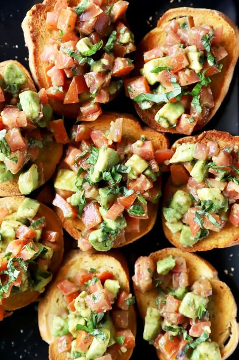 Avocado Bruschetta can be an elegant but easy way to start your dinner party. You'll love the addition of creamy avocado to the classic Italian appetizer. Italian Avocado Recipes, Bruschetta Recipe With Avocado, Avocado Crostini Appetizers, Avocado And Tomato Recipes, Smashed Avocado Bruschetta, Avocado Toast Appetizer Party, Avocado Bruchetta, Mexican Bruschetta, Appetizer Bruschetta