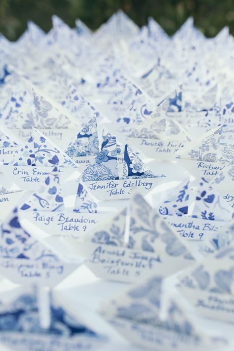 DIY origami sailboat wedding name cards in blue and white patterned paper. Coastal and beachy wedding placecards and seating chart. Sailboat Seating Chart, Coastal Place Cards, Coastal Wedding Place Cards, Beachy Seating Chart Wedding, Diy Coastal Wedding Decor, Summer Coastal Wedding, Coastal Elegant Wedding, Name Places For Wedding, Coastal Wedding Table Decor