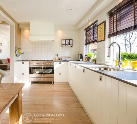 Top Cabinet Colors: Cotton White creates a dreamy, bright space in this kitchen. Color: Cotton White OW3 | Diamond Vogel Paint Oak Floor Kitchen, 70s Kitchen Remodel, Polyurethane Floors, Sliding Mirror Closet Doors, 70s Kitchen, Delaware Beaches, Kitchen 2024, Flooring Trends, Flooring Store