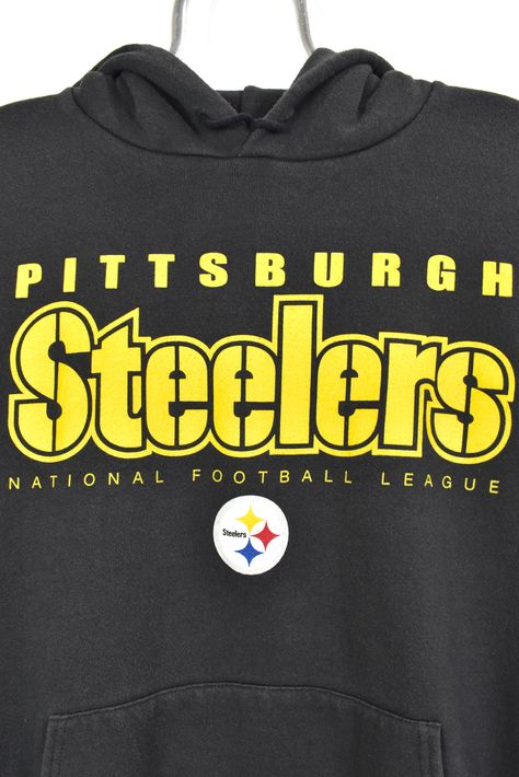 Vintage NFL Pittsburgh Steelers black hoodie | XXL Men Women Tshirtvibes. This classic shirt will give your outfit a little flair. Because comfort and design were given careful consideration throughout its creation, it is a versatile choice for both formal and casual settings. Invest in a new wardrobe by using this essential item. #pittsburgh steelers #nfl #Shirt #Tshirtvibes