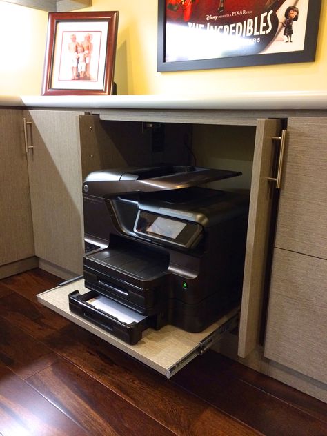 Printer hide - away!   Many of us are using our printers less these days and in a cozy home we generally do not want to see this large machinery out to clutter a fine designed home office. Pocket doors and sliding shelf makes for a neat hide-away for any printer or machine.  Created #HomeOffice by #Malka and #RCCabinetsandClosets of #Sonoma  #OfficePrinter #HomeOffice #InteriorDesign #ProfessionalOrganizer #ProfessionCabinetDesign #PrinterShelf #PrinterCabinet Hiding Printer In Home Office, Hide Printer In Office, Home Office With Printer, Large Printer Storage Ideas, Office Pocket Doors, Printer Table Ideas, Printer Storage Ideas, Office Decor Professional Work, Printer Drawer