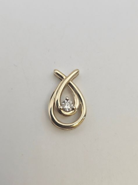 Vintage 10kt Yellow Gold Teardrop .15ct Round Cut Diamond Estate Pendant  Item w#1579 1. Vintage 10k Yellow Gold Teardrop Design - acid test to confirm metal content 2. .15 Carat Round Cut Diamond, Color J, Clarity SI2 3. Love Knot Pendant with Overlapping Teardrops 4. Clean and Good Condition Marked and Acid tested to confirm 10k gold *Please note that items crafted from 10k gold contain a lower percentage of pure gold and are mixed with other alloys, such as nickel, to enhance durability and strength. While 10k gold is a more affordable option, it may not be suitable for individuals with metal sensitivities, as the additional alloys can sometimes cause reactions. If you have known metal sensitivities, we recommend considering alternative metals or higher karat gold options.  Welcome to W Teardrop Diamond, April Birthday, Teardrop Pendant, Love Knot, Diamond Color, Pure Gold, Round Cut Diamond, 10k Gold, Estate Jewelry