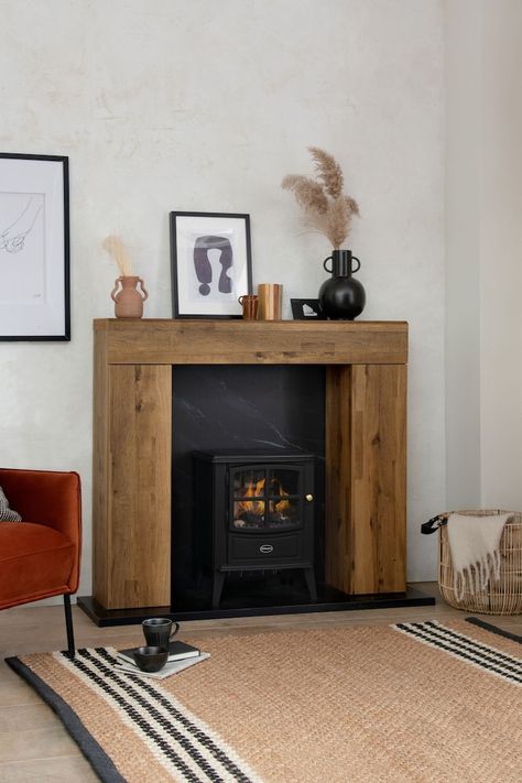 Dark Bronx Oak Effect Storage Fire Surround - Image 1 of 7 Electric Log Burner Living Room, Pink Feature Wall, Oak Beam Fireplace, Electric Log Burner, Beam Fireplace, Dark Wood Coffee Table, Log Burner Living Room, Fire Surrounds, Fire Surround