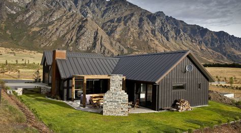 Exterior view of house with dark walls and cottage, elevation, farmhouse, home, house, hut, landscape, log cabin, mountain, mountain range, property, real estate, roof, siding, brown, gray Modern Black House Exterior, Modern Black House, Metal Barn, Shed Homes, Casa Exterior, Exterior Cladding, Barn Style House, Black House Exterior, Board And Batten