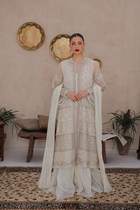 Esmeray is an ensemble of a long, ivory cotton net jacket, heavily decorated in silver and grey embellishments of resham, tilla and hand embroidered south Asian motifs further highlighted via the employment of Swarovski crystals. Paired with the top is a crushed, shimmery cotton sharara and a crushed dupatta in moon-light cotton net. Net Jacket, Cotton Sharara, Wedding Types, Wedding Mehndi, Silk Dupatta, South Asian, Fashion Consultant, Raw Silk, Cotton Lights