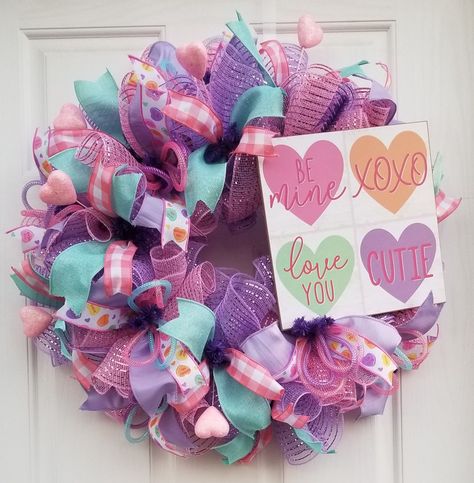 Nostalgic purple and pink conversation candy heart wreath with glitter heart picks and mesh tubing for door decor on February 14th Juneteenth Wreath, Valentine Wreath Craft, Winter Door Decor, February Winter, Pastel Wreath, Happy Juneteenth, Diy Valentines Day Wreath, Winter Door Decorations, Patriotic Wreaths