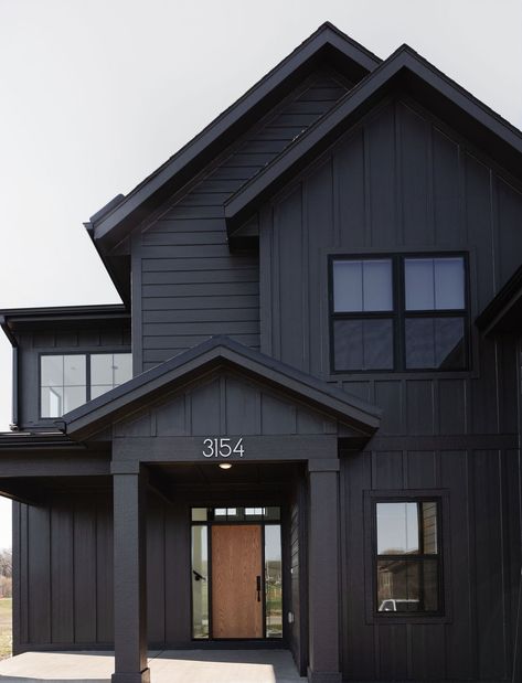 Black Home Exterior Palette Front Entry in the Whistling Straights home plan - WDM custom build. Built by Caliber Homes Iowa. Design @joelleelainedesign Photo: @brookepavel Black Farmhouse Exterior, Construction Painting, Gray House Exterior, Black Houses, Dark House, Extra Work, Paint Sheen, Grey Houses, Modern Farmhouse Exterior