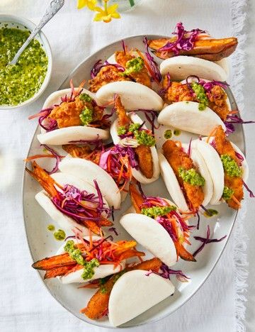 Large plate of bao buns filled with breaded chicken goujons, sweet potato or prawns topped with coleslaw and green sauce. Sweet And Sour Slaw, Fish Goujons, Party Food Recipes, Fakeaway Recipes, Blue Cheese Dip, Bao Buns, Best Party Food, Chilli Chicken, Dip Recipes Easy