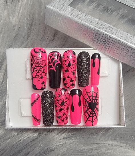 Please read full description. These nails are a beautiful bright pink with a little bit of everything. Handpainted black webs, black drips, and stitch design along with black sugar glittered ring fingers. Spiders, webs, and spooky art on every finger. Perfect for Halloween.  They are shown in a long square shape, but are available in multiple shapes, lengths, and sizes. I offer hand-painted press-on nails made with high quality Apres Gel-X soft gel nail tips and gel polish. Gel polish will give Hot Pink And Black Halloween Nails, Coffin Nails Designs Halloween, Pink And Black Nails Halloween, Pink Black Halloween Nails, Pink And Black Halloween Nails, Long Halloween Nails, Saved Nails, Nails Pink And Black, Luxury Halloween