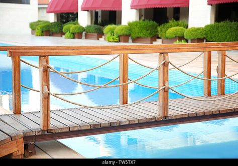 Wooden bridge over swimming pool in luxury hotel Stock Photo Pool Bridge, Lynn Canyon, Small Bridge, Luxury Swimming Pools, Thermal Spa, Natural Swimming Pool, Wooden Bridge, Blue Sky Background, Best Resorts