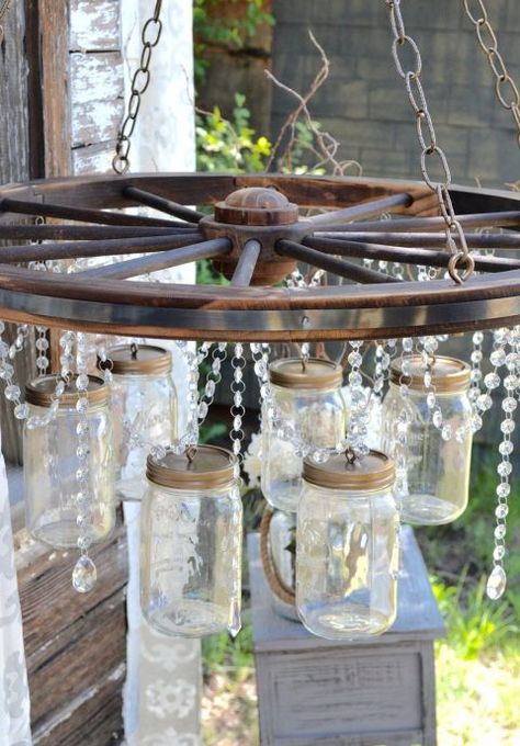 Wagon Wheel Garden, Wagon Wheel Decor, Mason Jar Light Fixture, Chandelier Diy, Jar Chandelier, Mason Jar Chandelier, Old Wagons, Wheel Decor, Diy Outdoor Decor