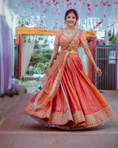 A Pretty kanjivaram lehenga for this beautiful bride. The intricate embroidered blouse adding oodles of charm to the ensemble. Couples with her subtle makeup and minimal jewellery the look is an inspiration to ape for. PC: barrys.photograph #indianwedding #wedding #indianbride #bride #southindianbride #southindianwedding #saree #kanjivaram #kanjivaramsaree #lehenga #wittyvows #indianjewellery Saree Lehenga Designs, Kanjivaram Lehenga, Bridal Half Saree, Saree South Indian, Engagement Dress For Bride, South Indian Wedding Saree, South Indian Bride Saree, Kanjeevaram Sarees, Half Saree Lehenga