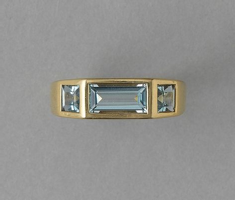 An 18 carat yellow gold ring with a baguette cut aquamarine (app. 1.3 carat) and two square cut aquamarines on the side, signed: Paloma Picasso for Tiffany & Co. weight: 6.65 gramssize: 19 mm / 9 USwidth: 3 – 7 mm Hessonite Ring, Ruby Eternity Ring, Cartier Gold, Diamond Dress Ring, Art Deco Brooch, Paloma Picasso, Heart Pendant Gold, Sell Gold, Ruby Earrings