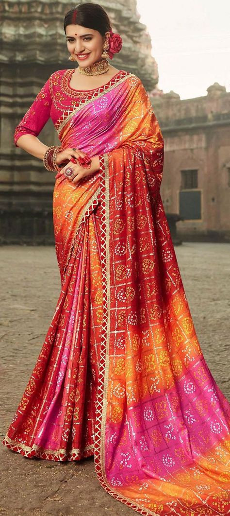 As a fashionista, you need to keep track of the ever-changing fashion styles, so you are always seen in the latest and the best. So, Let's check out some new trendy collection of #Rajasthanibandhanisarees at #Indianweddingsaree.   Work: Bandhej, Lace, Printed  Color Family: Multicolor  Style: Rajasthani  You can order this Silk Festive Saree in Multicolor with Lacework and it will be delivered on your doorsteps @ IndianWeddingSaree. Multicolor Saree, Bandhej Print, Sari Lehenga, Rajasthani Dress, Party Wear Sarees Online, Wedding Sarees Online, Lehenga Blouse Designs, Lehenga Wedding, Indian Saree Blouse