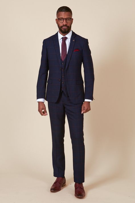 Ticking all the boxes, this men's navy three piece is simple and sophisticated in its design. Cut to a slim tailored fit, it features a deep burgundy check laden on a subtle navy Prince of Wales check. Added elastane ensures flexible easy wear that will keep you comfy from the aisle to the dancefloor. Perfect for tying in with a rich burgundy wedding theme, this suit will work for all the groomsmen. Try switching up the waistcoat for a varied look and to match the bridesmaids. Also available in Navy Suit Maroon Tie, Navy Blue Suit With Burgundy Tie, Blue Suit Burgundy Tie Wedding, Blue Suit Burgundy Tie, Mens Suits Wedding Guest, Navy Suit Outfit Men, Blue And Burgundy Suit, Three Piece Suit Mens Wedding, Wedding Navy Suit