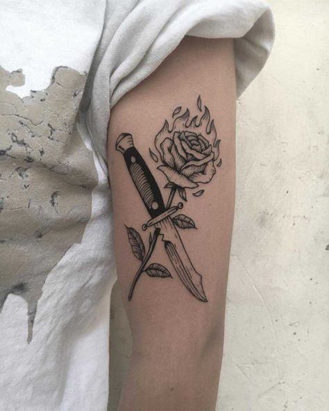 Knife and burning rose tattoo inked on the left upper arm Knife And Rose Tattoo, Rose And Dagger Tattoo, Rose Tattoo Stencil, Rose Tattoo Meaning, Knife Tattoo, Omerta Tattoo, Skeleton Hand Tattoo, Fire Tattoo, Rose Tattoo Design