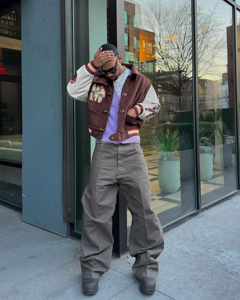 How about his color? 🍩 Outfit info 👇🏻 • • • 📸 @sylves1er 🇺🇸 🕶️Eyewear : basketcase 🧥Outer : be you 👔Top : jooniverse lab 👖Bottom : rick owens online 👞Shoes : bottega veneta • • • • • • brown varsity jacket, purple vest, gray baggy pants, boots, sunglasses, men’s outfit, usa Gray Baggy Pants, Gray Shoes Outfit, Brown Varsity Jacket, Outfit Info, Purple Vest, Pants Boots, Purple Vests, Varsity Jackets, Sunglasses Men