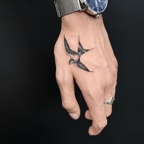 Explore 2024's Top Bird Tattoo Styles for Men: Discover Symbolism & Artistry Swallow Hand Tattoo, Bird Hand Tattoo, Natur Tattoo Arm, Simbolos Tattoo, Swallow Bird Tattoos, Herren Hand Tattoos, Wing Tattoo Men, Bird Tattoo Men, Tatuagem Masculina Pequena