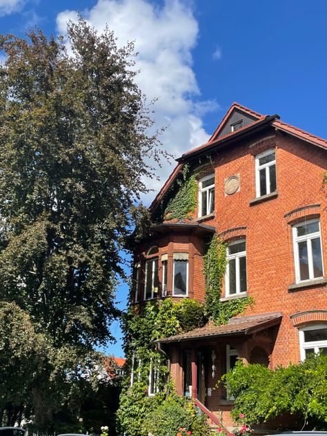 sunny day vibes at this charming old red stone house in southern germany ☀️ / german architecture / historic homes / countryside charm / sunny days / old world beauty / rural life germanredhouse / architecturalcharm / vibrantfacade / homeandgarden / plantlife / cozyresidence / europeanarchitecture / redblockbeauty / germanhomes / urbanflorals German Stone House, Red Stone House, German Core, House In Germany, Houses In Germany, German Architecture, Southern Germany, World Beauty, Countryside House