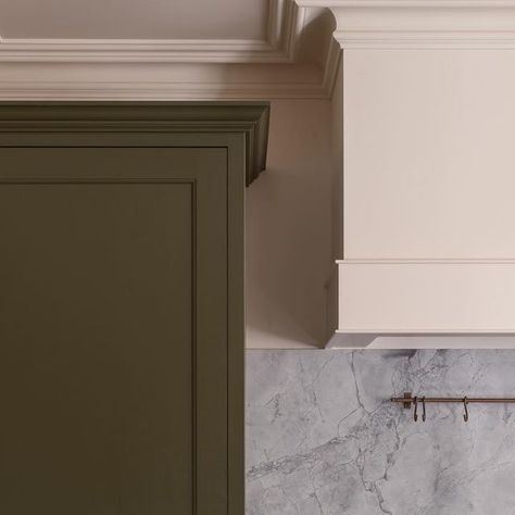 Emma Milne on Instagram: "Dreamy fridge hidden behind the most perfect green cupboard from @plainenglishdesign in this kitchen designed together for our clients.   I love the perfect cornice of the cupboard which mirrors the cornicing in the room which is also carried around the extractor canopy.   Every detail has been considered.  • interiors @emmamilneinteriors • • kitchen @plainenglishdesign • • photo @hana.snow •" Cornice Kitchen Cabinets, Green Alcove Cupboards, Green Kitchen Range Hood, Calke Green Farrow And Ball Kitchen, Pistacio Green Cabinet, Green Larder Cupboard, Kitchen Cornice, Green Cupboard, Kitchen Extractor