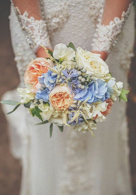 Blue hydrangeas were the basis for the bouquets and centrepieces, along with larkspur, white and peach roses, eucalyptus and ivy and white liatris, sweet peas and freesias. (photo by Howell Jones Photography) Bridal Bouquet Coral, Peach Wedding Colors, Orange Bridal Bouquet, Blue Wedding Centerpieces, Hydrangea Bouquet Wedding, Red Bouquet Wedding, Beautiful Bridal Bouquet, White And Pink Roses, Blue Wedding Bouquet