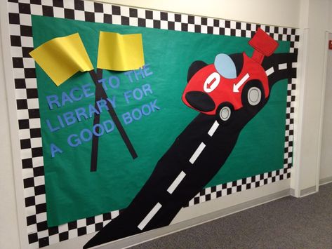 Race car library bulletin board. Race to the library for a good book. The border is 3" black squares on white construction paper. Race To The Finish Line Bulletin Board, Racetrack Bulletin Board, Race Track Bulletin Board Ideas, Car Bulletin Board Ideas, Race Car Classroom Theme Bulletin Boards, Racing Theme Classroom, Racing Bulletin Board Ideas, Race Car Bulletin Board Ideas, Race Car Bulletin Board