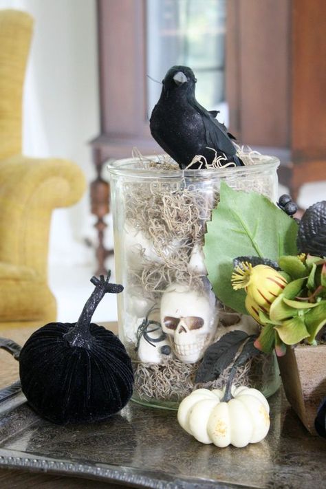 a glass jar with hay and skulls, some faux pumpkins, greenery and a blackbird on top for Halloween Halloween Party Centerpieces, White Pumpkin Centerpieces, Halloween Centerpieces, Masquerade Decorations, Lanterns Diy, Halloween Weddings, Spooky Halloween Crafts, Spooky Halloween Decor, Centerpieces Ideas