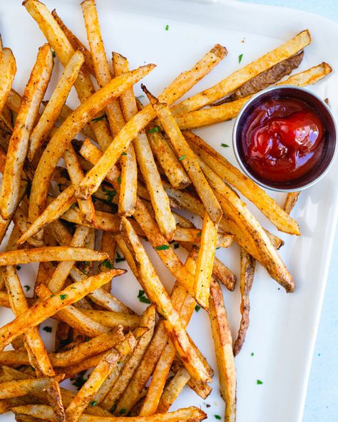 These seasoned fries taste even better than a restaurant! Bake them until crispy with this magic seasoning blend and prepare to be amazed. #seasonedfries #bestfries #homemadefries #bakedfries #frenchfries #friesrecipe #frenchfriesrecipe Oven French Fries, French Fry Recipe Baked, Oven Baked French Fries, Baked French Fries, Oven Baked Fries, Crispy Oven Fries, Healthy Fries, Seasoned Fries, A Couple Cooks