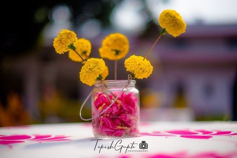 Photo of Floral centrepiece with marigolds and rose petals Reusable Wedding Decor, Floral Centrepiece, Indian Wedding Planning, Painted Wine Bottles, Floral Centerpiece, Eco Friendly Wedding, Tiger Lily, Wedding Images, Floral Centerpieces