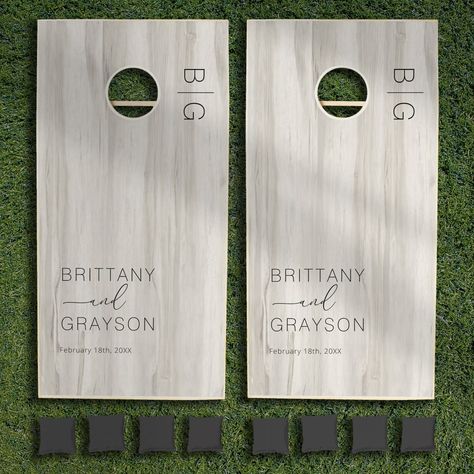 Personalized wedding cornhole set featuring a light rustic wood print background, the initials, the bride & grooms names, and the wedding date. Cornhole Wedding Boards, Personalized Cornhole Boards, Backyard Engagement Party Decorations, Backyard Engagement, 2026 Wedding, Wedding Cornhole Boards, Wedding Cornhole, Bean Bag Boards, Corn Hole Boards