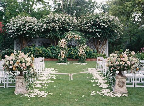 Two cast-iron urns on vintage plinths mark the beginning of this aisle, which is styled with ivory rose petals. Pride And Prejudice Wedding Theme, Petals Down The Aisle, Pride And Prejudice Wedding, A Secret Garden, Secret Garden Wedding, Charlottesville Wedding, Pride Prejudice, Wedding Inspired, Crystal Chandeliers