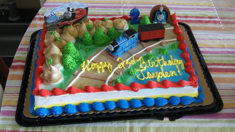 This time I decided to just order a train cake at Kroger (supermarket) it was too much work last year to make the cake and we were icing it when guests arriving. A girl has got to do what a girl has got to do and if your budget says sheet cake with miniature toys on top that's fine too. Train Sheet Cake, Train Birthday Party Cake, Light Blue Theme, Choo Choo Train Birthday Party, Thomas Train Birthday, Thomas Train Cake, Thomas Cakes, Train Birthday Cake, Train Birthday Party