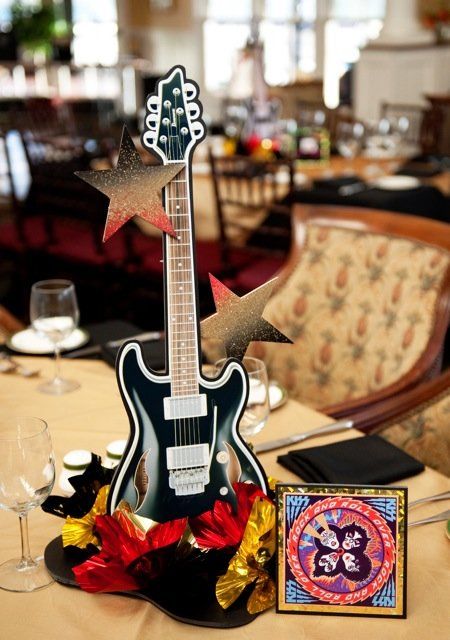 classy guitar centerpiece Concert Table Decorations, Rock N Roll Party Centerpieces, Rock And Roll Centerpiece Ideas, Guitar Centerpieces, Guitar Party Decorations Ideas, Guitar Centerpiece Ideas, Rock Theme Centerpieces, Rock And Roll Birthday Party Centerpieces, Music Inspired Centerpieces