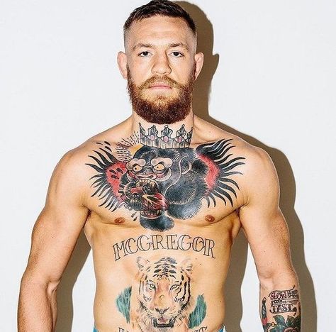 McGregor's chest tattoo is one of his most renowned tattoos in the tattoo industry. The tattoo portrays an enraged gorilla devouring a heart, representing the savage personality he has. The tattoo design was inspired by the gorilla logo of the Straight Blast Gym-Ireland, where McGregor used to train. Conor Mcgregor Haircut, He Man Tattoo, Conor Mcgregor Tattoo, Conor Mcgregor Wallpaper, Conner Mcgregor, Bodybuilding Tattoo, Tato Dada, Connor Mcgregor, Gorilla Tattoo