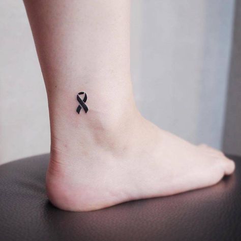 Black ribbon tattoo on the ankle. Small Ribbon Tattoo, Purple Ribbon Tattoos, Pink Ribbon Tattoos, Survivor Tattoo, Awareness Tattoo, Ribbon Tattoos, Small Meaningful Tattoos, Tattoo Meaning, Ankle Tattoo