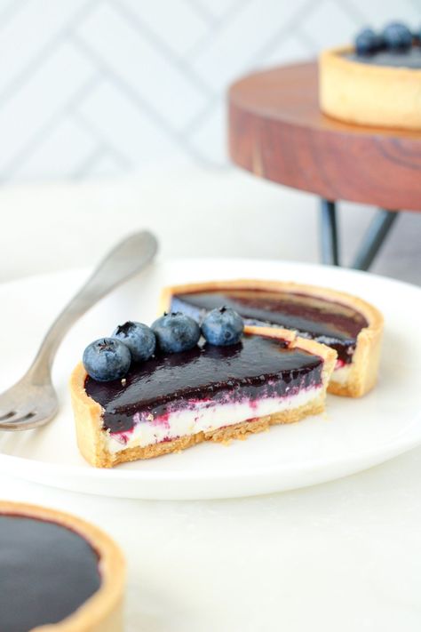 These mini blueberry tarts are made with a lemon zested pastry shell, lemon cream cheese mousse, and fresh blueberry coulis. You'll love each bite of these homemade tarts. Get the recipe from Bakes & Blunders. #blueberry #pastry Homemade Tarts, Blueberry Pastry, Blueberry Coulis, Blueberry Tarts, Cream Cheese Mousse, Delicious Lemon Desserts, Cheese Mousse, Homemade Cherry Pies, Candied Lemon Peel