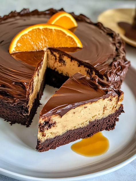 Chocolate Orange Cheesecake Layer Cake 

🍊 Ingredients 🍊
For the Chocolate Cake:
2 cups sugar 🍬
2 cups all-purpose flour 🥣
3/4 cup cocoa powder 🍫
2 tsp baking powder 🧂
1 tsp baking soda 🧪
1/2 tsp salt 🧂
2 eggs 🥚🥚
1 cup soured milk 🥛
1 cup black coffee ☕
1/2 cup vegetable oil 🛢️
1 tsp vanilla extract 🍦
2 oz orange liqueur (optional) 🍊🍸
For the Orange Cheesecake:
1 ½ pounds (3 blocks) cream cheese 🧀
1 cup sugar 🍬
3 eggs 🥚🥚🥚
1 tsp vanilla extract 🍦
3/4 cup whipping cream 🥛 Chocolate Orange Cheesecake Layer Cake, Triple Layer Cheesecake, Orange Chocolate Cheesecake, Cheesecake Layer Cake, Chocolate Ganache Glaze, Chocolate Orange Cheesecake, Chocolate Covered Strawberry Cake, Chocolate Orange Cake, Orange Cheesecake