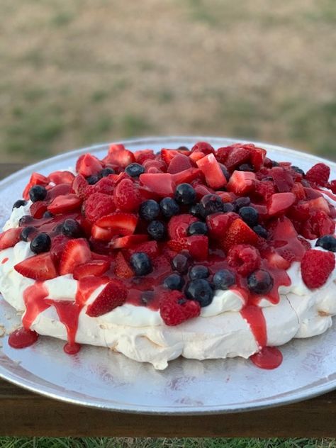 PAVLOVA WITH BERRIES AND CREAM RECIPE I first experienced a Pavlova at a luncheon hosted by the mother of my daughters’ childhood friend, more than 20 years ago. The beautiful hostess was named Anne Marie and this delicate dessert made quite an impression on me! What is a Pavlova? It’s a delicate crisp meringue bottom, filled, in this case, with cream and berries. The crisp sugar meringue with the rich cream and tart berries is an outstanding sweet bite of goodness. Mary Berry Pavlova, Berries And Cream Recipe, Red Foods, Berry Coulis, Berries And Cream, Vanilla Filling, Pavlova Recipe, Berries Recipes, Recipe Blog