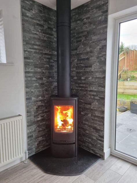 Contura 810 stove next to a window Corner Log Burner, Brick Fireplace Remodel, Wood Burning Stove Corner, Corner Wood Stove, Wood Stove Surround, Wood Burner Stove, Corner Stove, Log Burner Living Room, Stove Installation