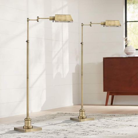 Set of 2 floor lamps. Adjustable from 44" to 54". Arm extends maximum of 20". Bases are 9" wide. Shades are 8" wide x 5 1/2" deep x 3 1/4" high. Weigh 13 lbs. Each uses one maximum 60 watt standard-medium base bulb (not included). On-off switch on lamp head. Set of traditional swing arm pharmacy floor lamps from the Regency Hill brand. Adjustable features allow you to easily position the lights for reading and other tasks. Adjustable height and swing arm. Lamp head is not adjustable. Place next to a favorite reading chair or sofa. Aged brass finish. Metal construction. 6-foot long black cords with a black finish plug.  These adjustable swing arm pharmacy floor lamps feature a metal tent shade that creates warm downward light ideal for reading or tasks. A convenient swing arm allows for adj Arm Lamp, Pharmacy Floor Lamp, Lamp Head, Head Set, Floor Standing Lamps, Reading Chair, Outdoor Lights, Fan Lamp, Traditional Lighting