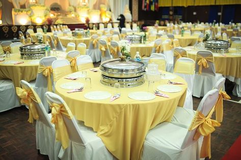 Celebrate your big day in style with a classic wedding banquet setup! Each table is dressed in a bright yellow polyester tablecloth that adds a pop of color and joy to the room, layered on top of a crisp white polyester tablecloth. White polyester chair covers with gorgeous yellow satin chair sashes are tied on each chair, creating a seamless and elegant look. Guests will dine in style with white round charger plates, tall clear plastic cups, and silver plastic utensils, all perfectly arranged o Yellow Tablecloth, Plastic Utensils, Yellow Satin, Chair Sashes, Charger Plates, Round Tablecloth, Chair Covers, Wedding Classic, Event Decor