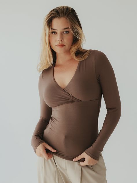 A wrap top with built-in padding so you don't have to worry about what bra to wear. It's made with a soft and stretchy fabric and has our first ever hybrid support band under the chest. This band is a durable elastic wrapped in our modal fabric and only placed in the front of the brami for a smooth back look. Fabric: 92% Modal 8% Spandex Details: Wrap front design, long sleeves, full length Support Level: Medium Fit: True to Size Internal Structure: Hybrid band What Bra To Wear, Wrap Top Long Sleeve, Modal Fabric, Photography Women, Wrap Top, Front Design, Vintage Photography, Stretchy Fabric, Empire Waist